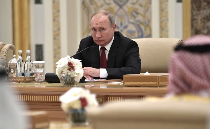 Владимир Путин сидит за столом