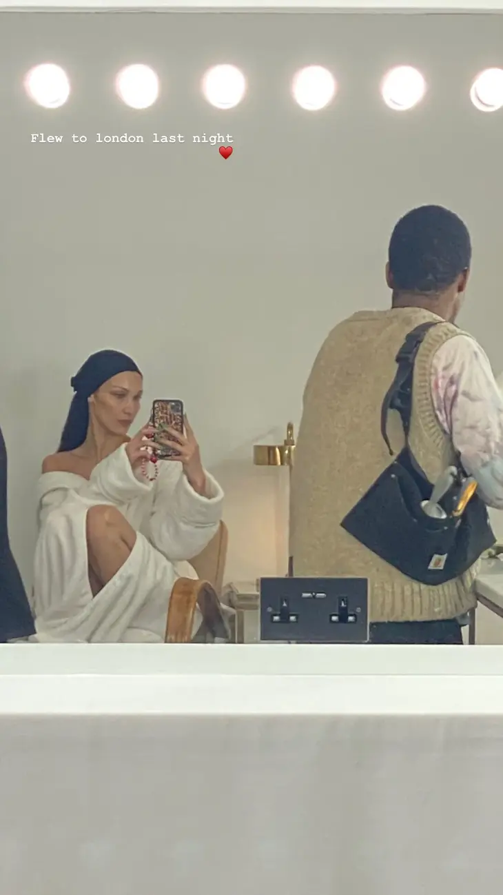 Bella Hadid flashes her bare knees in a robe