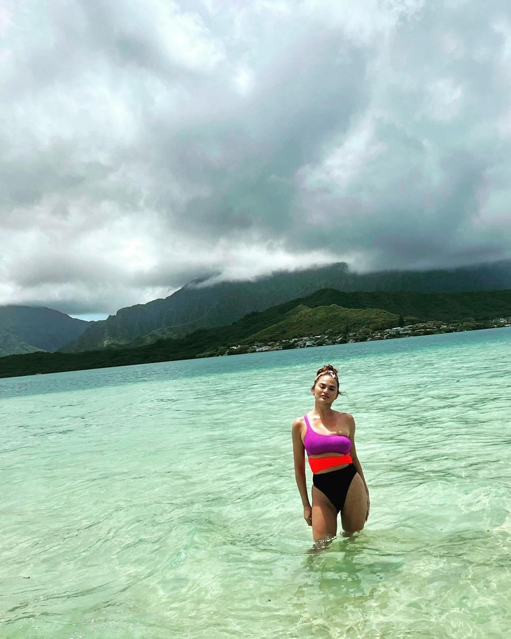 Chrissy Teigen flashes her toned body in a color block monokini