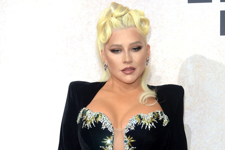 PHOTO: Christina Aguilera pops up her assets in a plunging black gown during the amfAR Gala Cannes