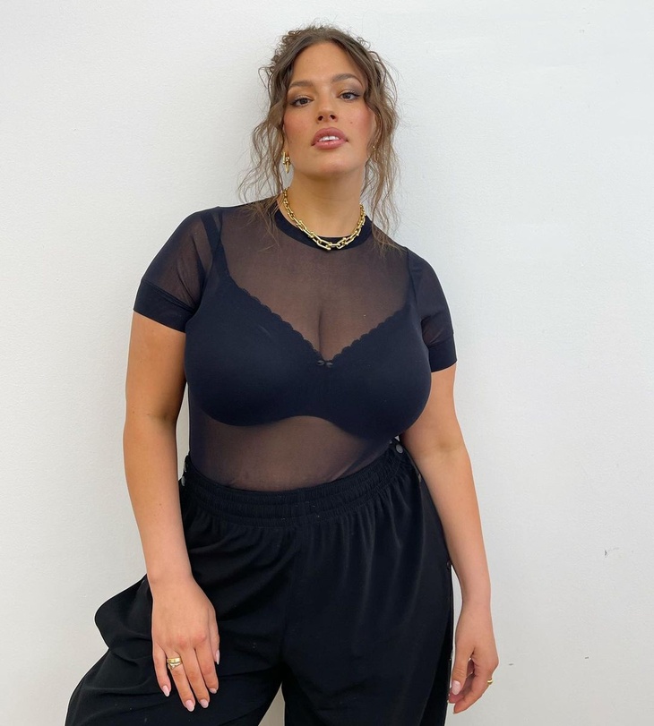 PHOTO: Ashley Graham showcases her ample cleavage in a bra and a sheer top